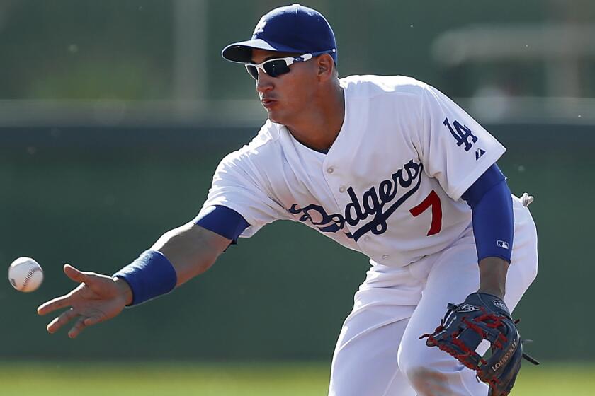 Dodgers infielder Alex Guerrero tosses a ball during a spring training practice session on Feb. 14. Guerrero is expected to be used primarily as a pinch-hitter during the final month of the regular season.