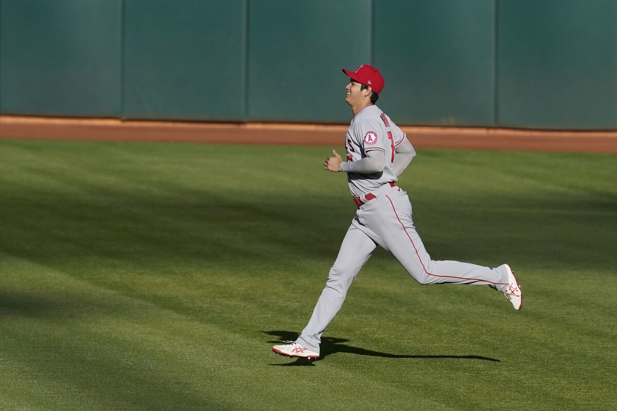 Angels designated hitter Shohei Ohtani warms up before Thursday's game against the Oakland Athletics.