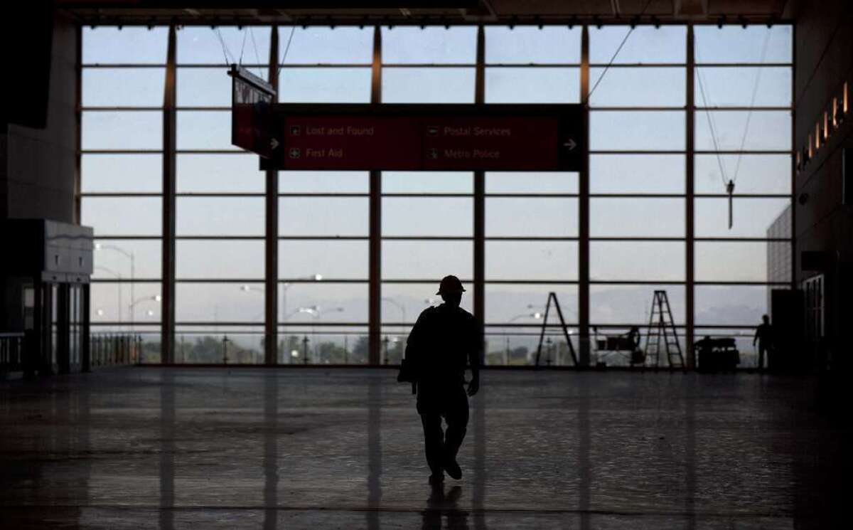 A construction worker is silhouetted at Vegas' McCarran airport, the setting for an overnight DIY music video by a stranded passenger.