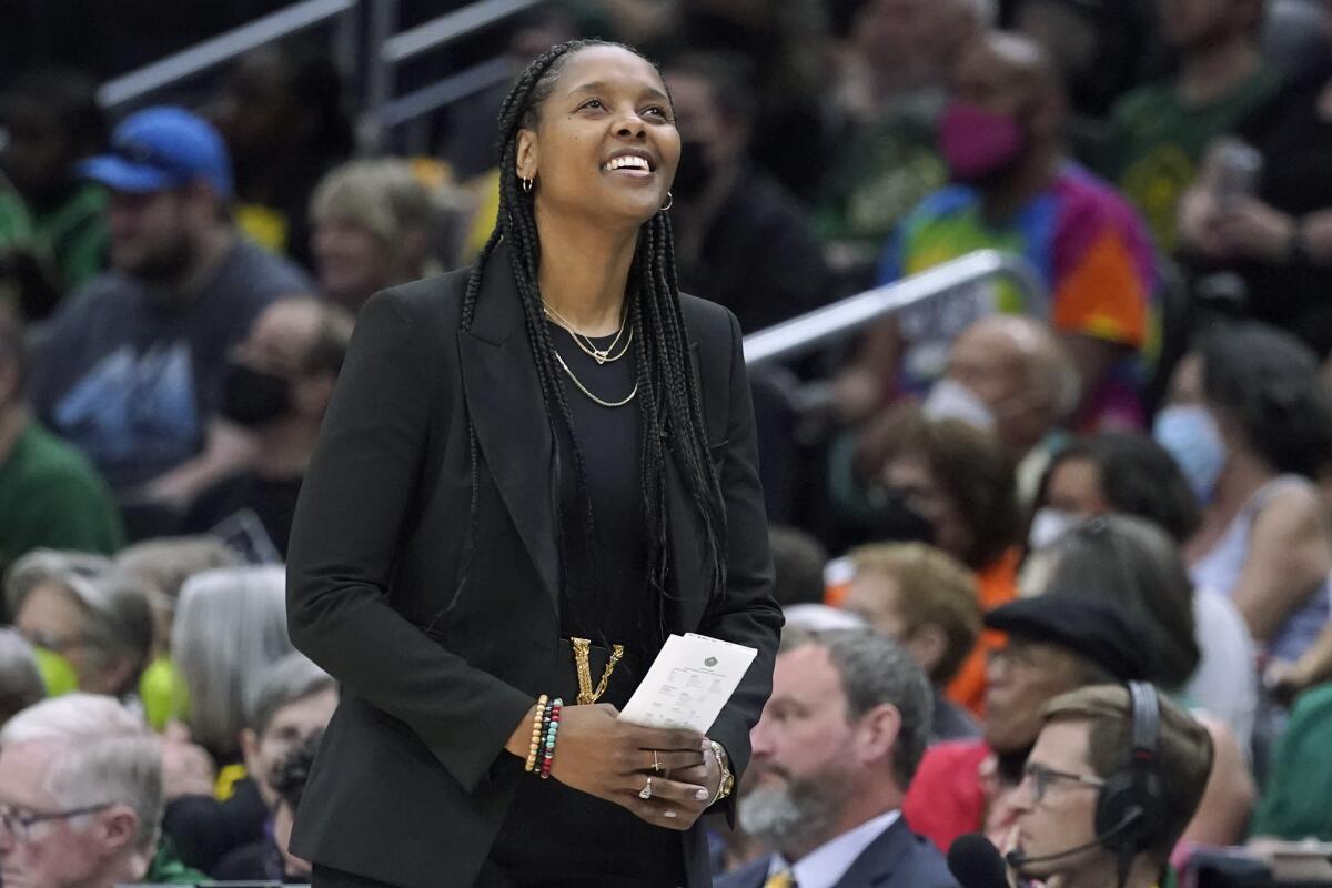 Seattle Storm head coach Noelle Quinn looks toward the scoreboard during the first half of a WNBA basketball playoff game against the Washington Mystics, Sunday, Aug. 21, 2022, in Seattle. (AP Photo/Ted S. Warren)