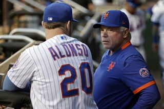 New York Mets manager Buck Showalter talks with Pete Alonso (20) before the first inning of a baseball game against the Los Angeles Dodgers on Wednesday, Aug. 31, 2022, in New York. (AP Photo/Adam Hunger)