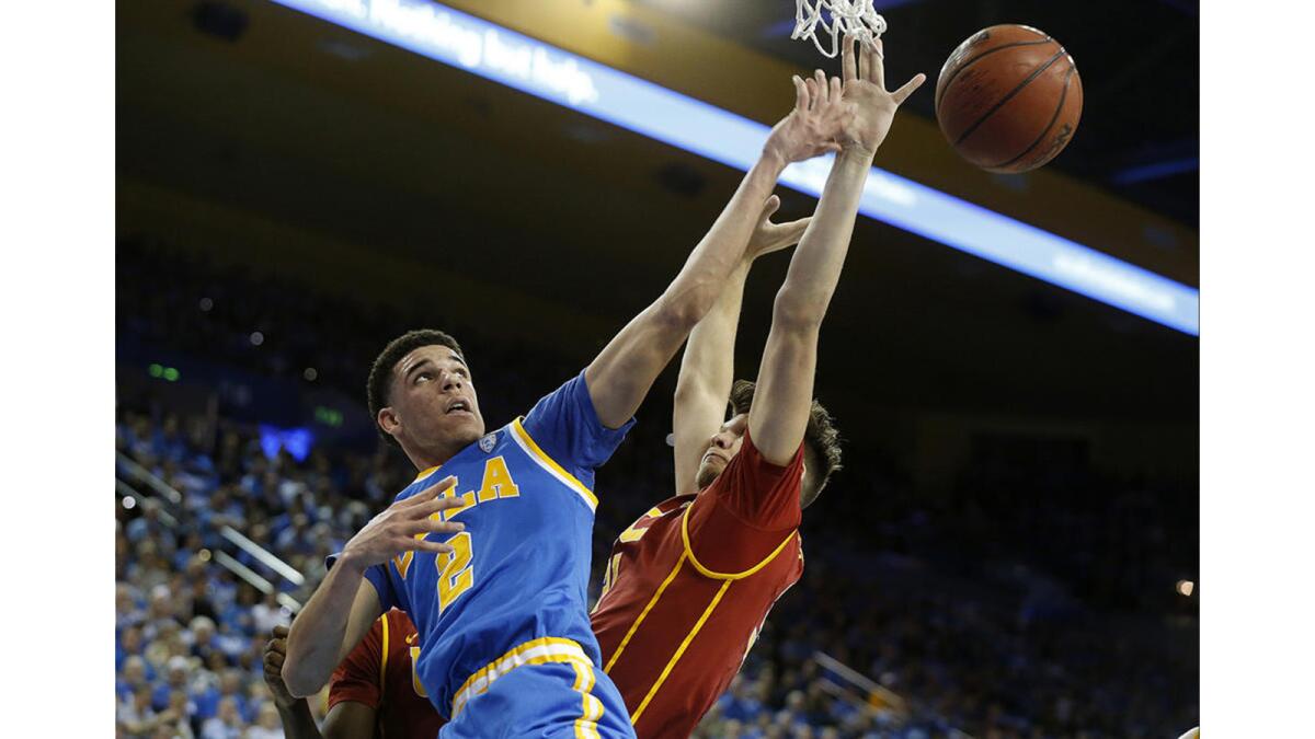 UCLA guard Lonzo Ball (2) has the ball knocked away guarded by USC forward Nick Rakocevic (31) in the first half at Pauley Pavilion.