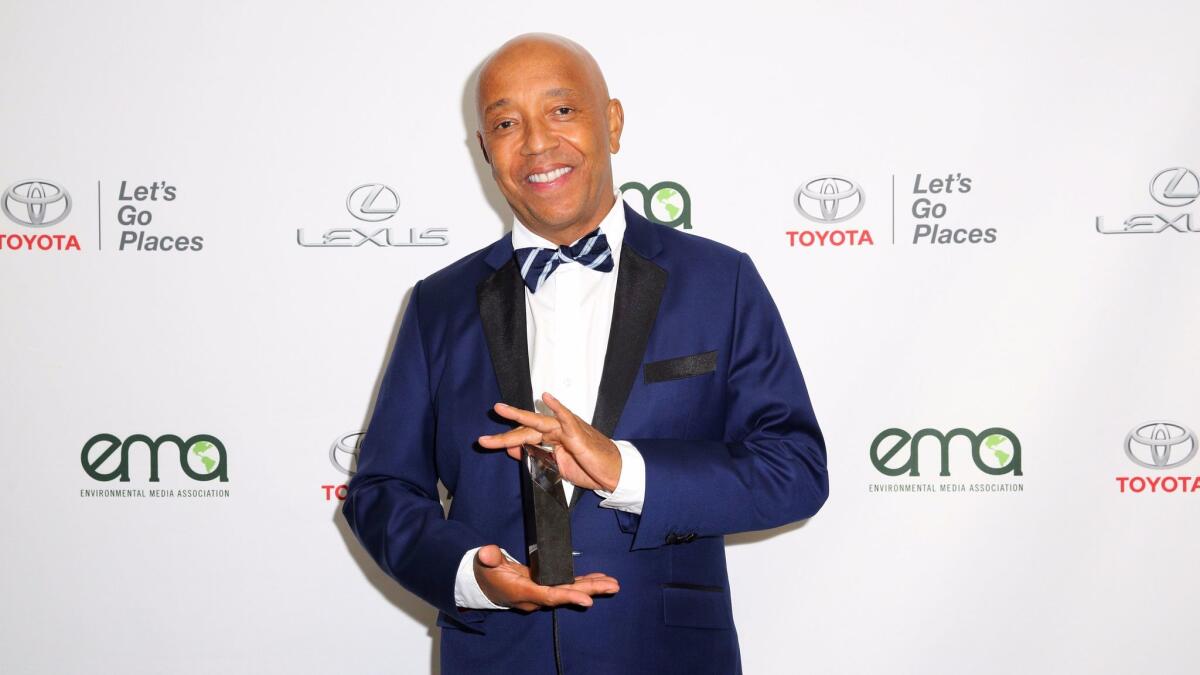 A woman filed a police report in 2001 accusing Def Jam Recordings co-founder Russell Simmons, shown, and filmmaker Brett Ratner of sexual battery.