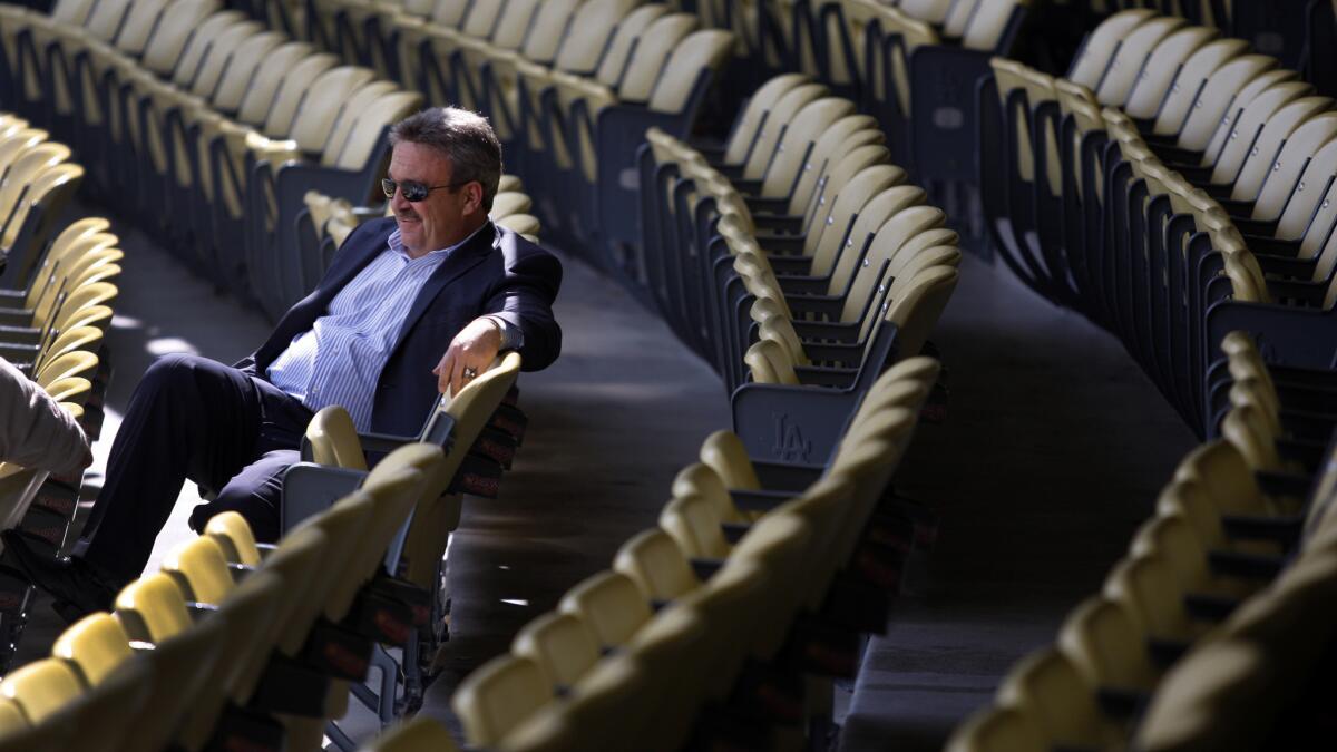 Former Dodgers general manager Ned Colletti relaxes in the field-level seats at Dodger Stadium before an exhibition game against the Angels in 2012.