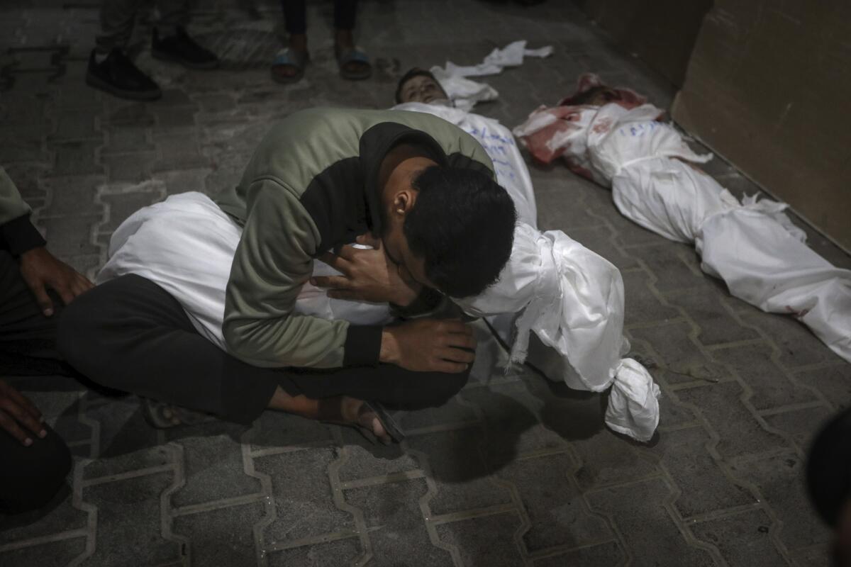 A Palestinian youth mourns his relative killed in the Israeli bombardment.