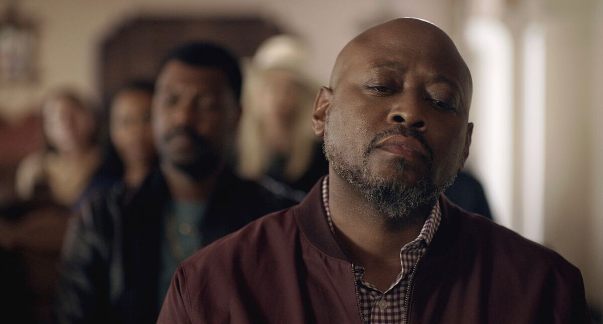 Sitting with a contemplative expression, actor Omar Epps portrays a recovering addict in a scene from 'The Devil You Know.'