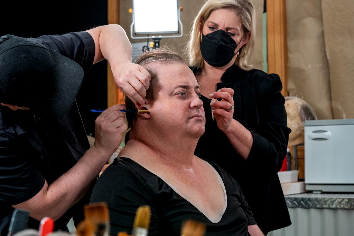 Makeup artists work on actor Brendan Fraser to turn him into the character of Charlie for "The Whale."