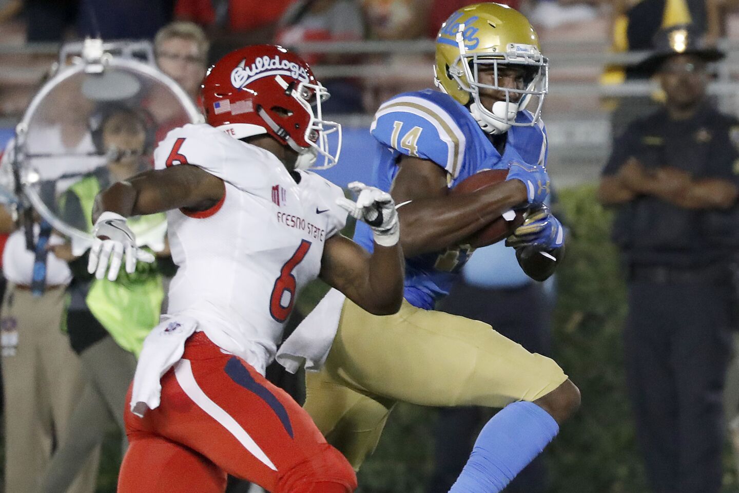 UCLA wide receiver Theo Howard breaks away for a touchdown after making catch in front of Fresno State defensive back Tank Kelly in the second quarter on Saturday.
