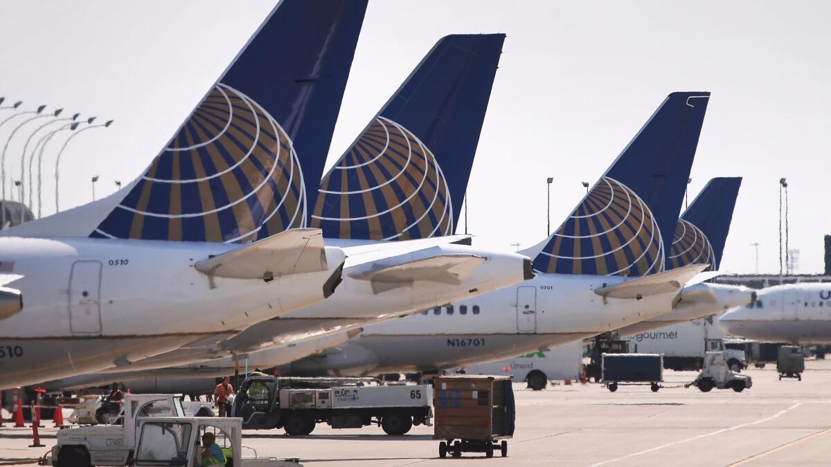 United Airlines jets sit at gates at Chicago's O'Hare International Airport. The airline plans to adopt changes to its loyalty reward program that include prices that vary for flights based on demand.