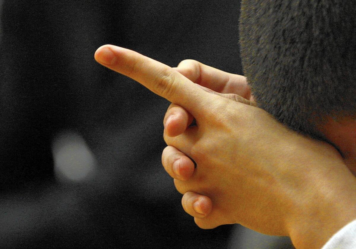 A juvenile inmate prays during a religious service at Sylmar Juvenile Hall in 2013.