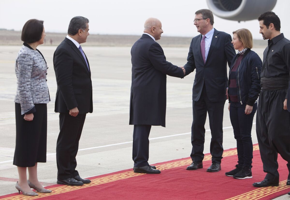 Defense Secretary Ashton Carter, second from right, is welcomed by Karim Sinjari, interior minister of the Kurdish Regional Government, after arriving in Irbil, Iraq.