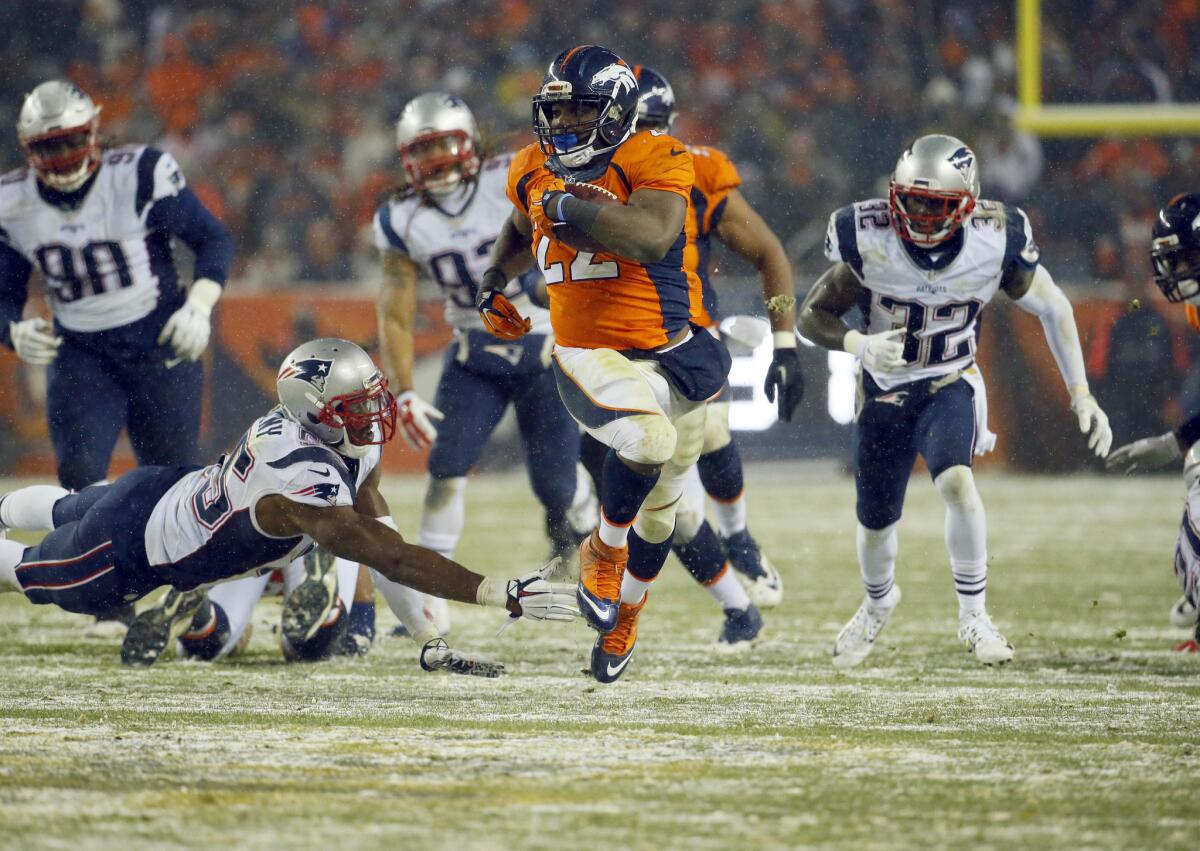 Broncos running back C.J. Anderson (22) breaks free for the game-winning touchdown against the Patriots in overtime.