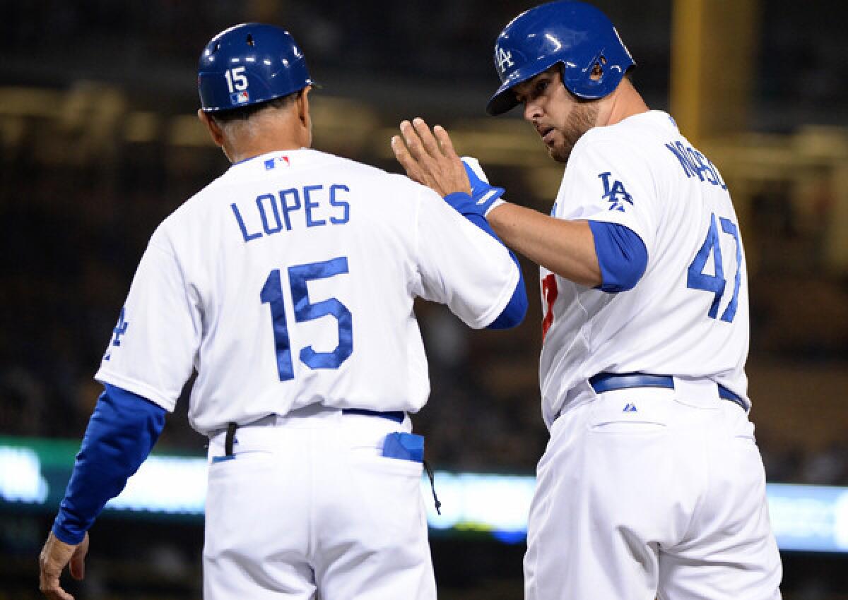 Veteran pitcher Ricky Nolasco, who the Dodgers acquired in a mid-season trade from the Miami Marlins, is congratulated by first base coach Davey Lopes after getting a hit against the New York Mets last month. Nolasco is a lifetime .140 hitter in eight seasons, and he's batting .200 with one RBI and four sacrifice bunts for the Dodgers.