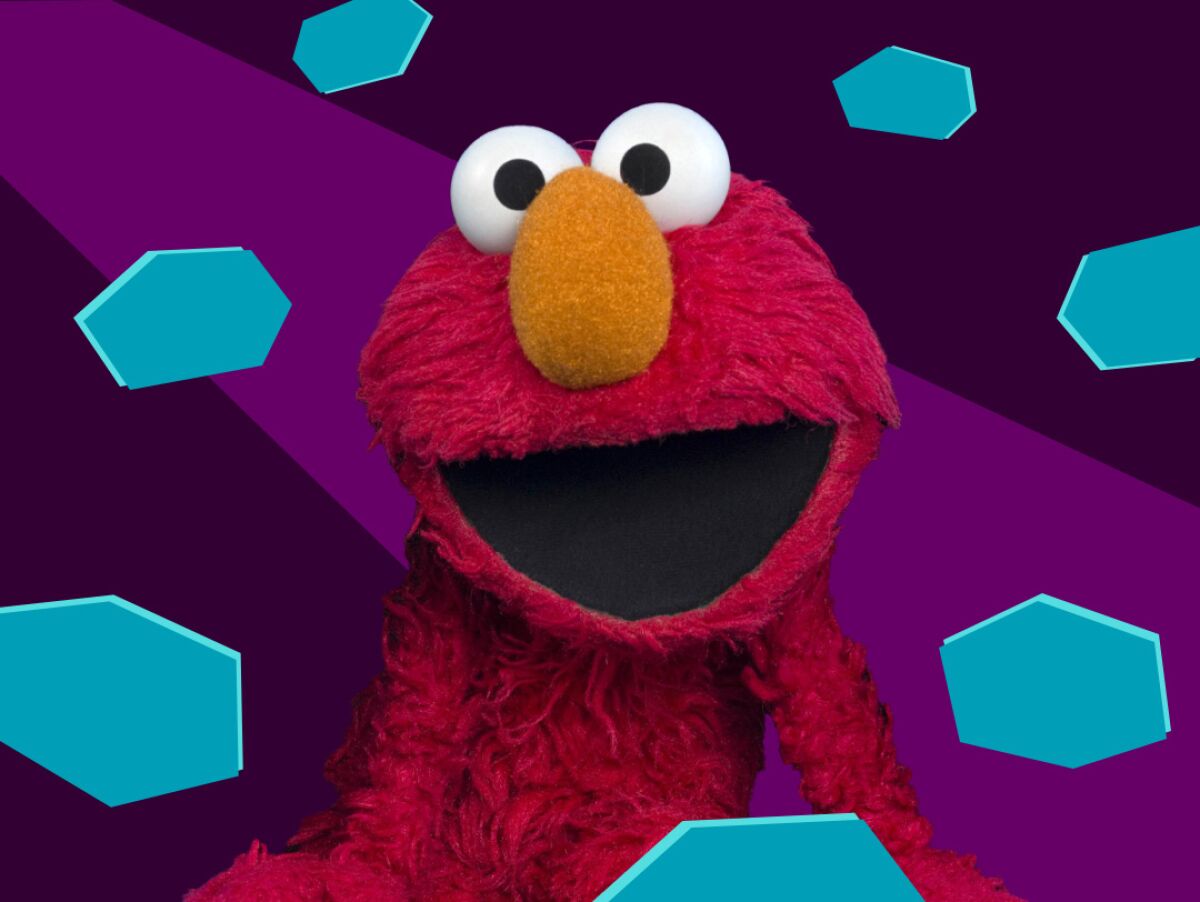 The red muppet Elmo from "Sesame Street" faces the camera with his mouth open.