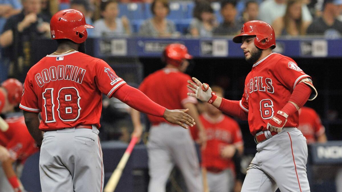 Angels left fielder Brian Goodwin congratulates teammate David Fletcher on his two-run home run during the Angels' 5-3 victory over the Tampa Bay Rays on Saturday.