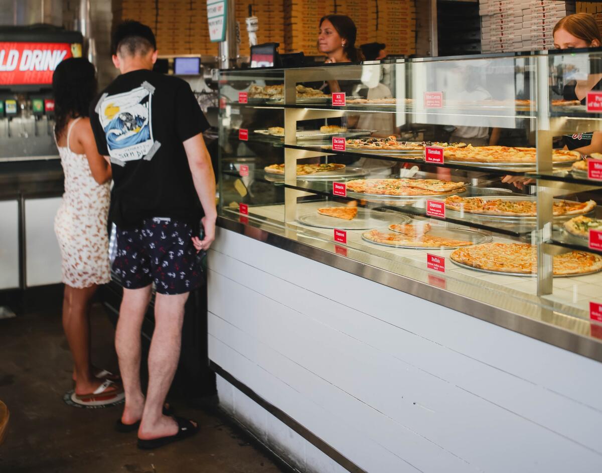 Pizza on Pearl puts its varieties on display in a big glass case.