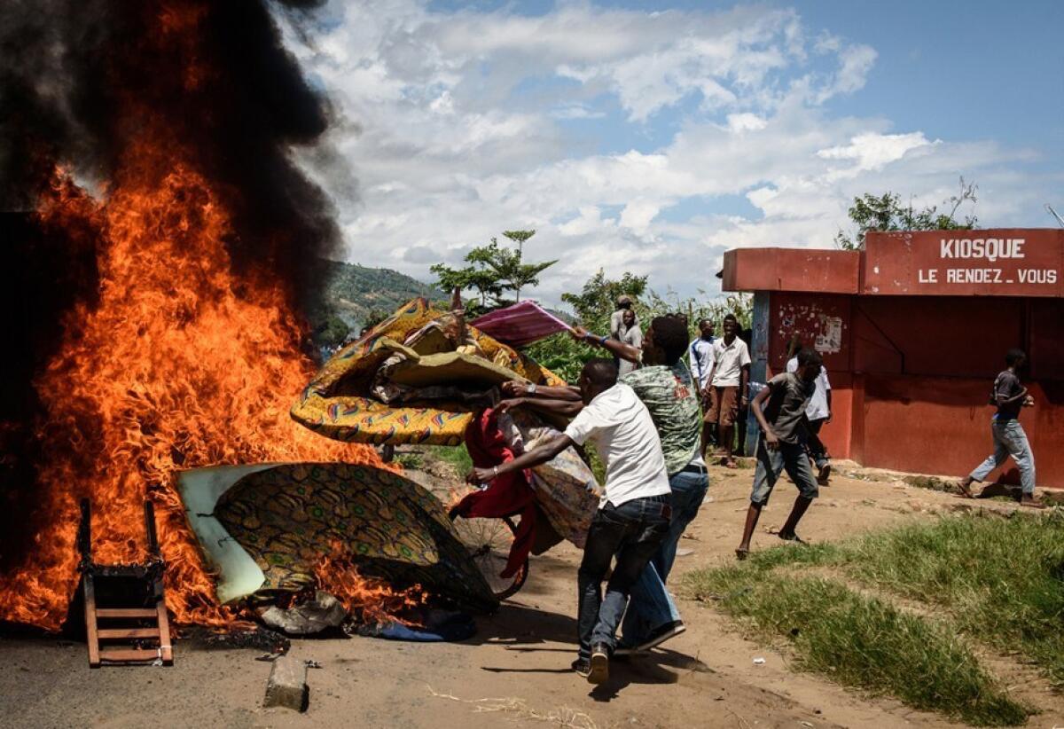 People burn mattresses looted from the local police post in Bujumbura, the capital of Burundi, on Wednesday during a protest against President Pierre Nkurunziza's bid for a third term in office.
