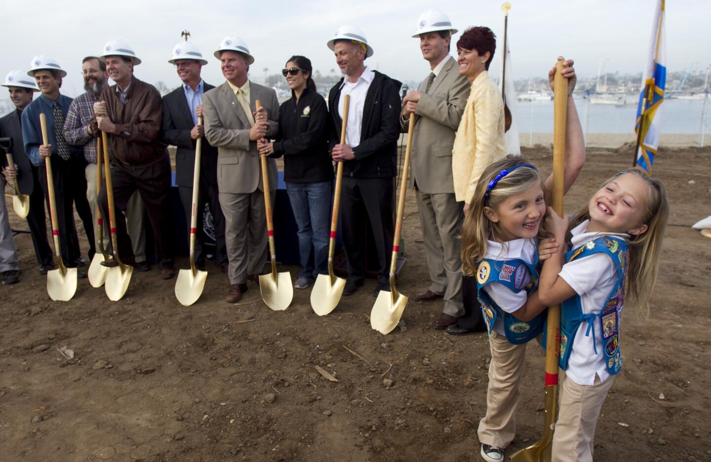 Girl Scouts Frankie Paalman and Kelly Richards pose for a photo op in front of city officials during the groundbreaking ceremony for Marina Park on Balboa Peninsula on Tuesday, February 11. (Scott Smeltzer, Daily Pilot)