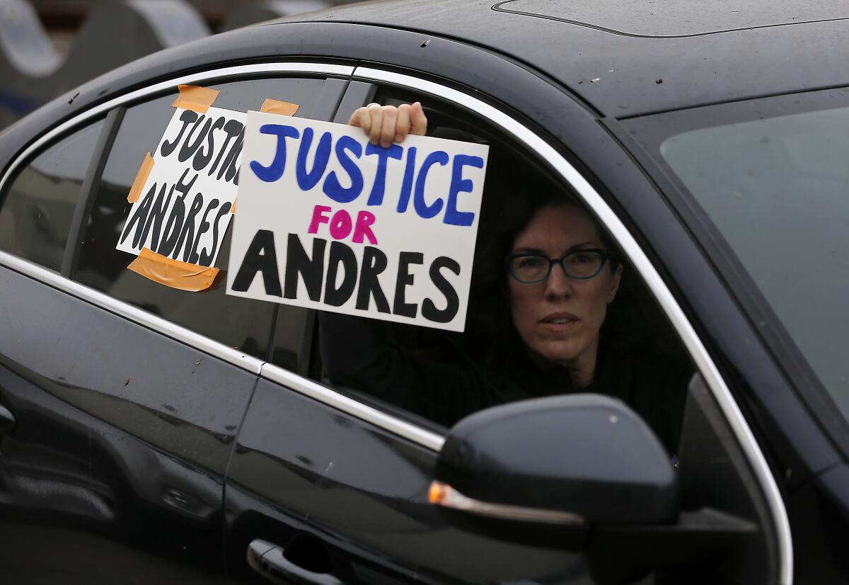 Protesters in cars drive around the Compton Civic Center on Thursday.