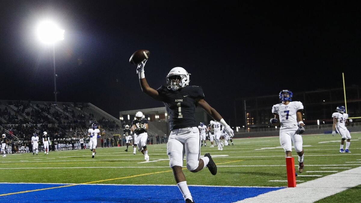 Narbonne running back Jermar Jefferson (1) scores on a 31-yard run with Crenshaw linebacker Patrick Willis, Jr (7) trailing behind in the fist half of the City Section Open Division football championship game on December 1, 2017 at El Camino College.