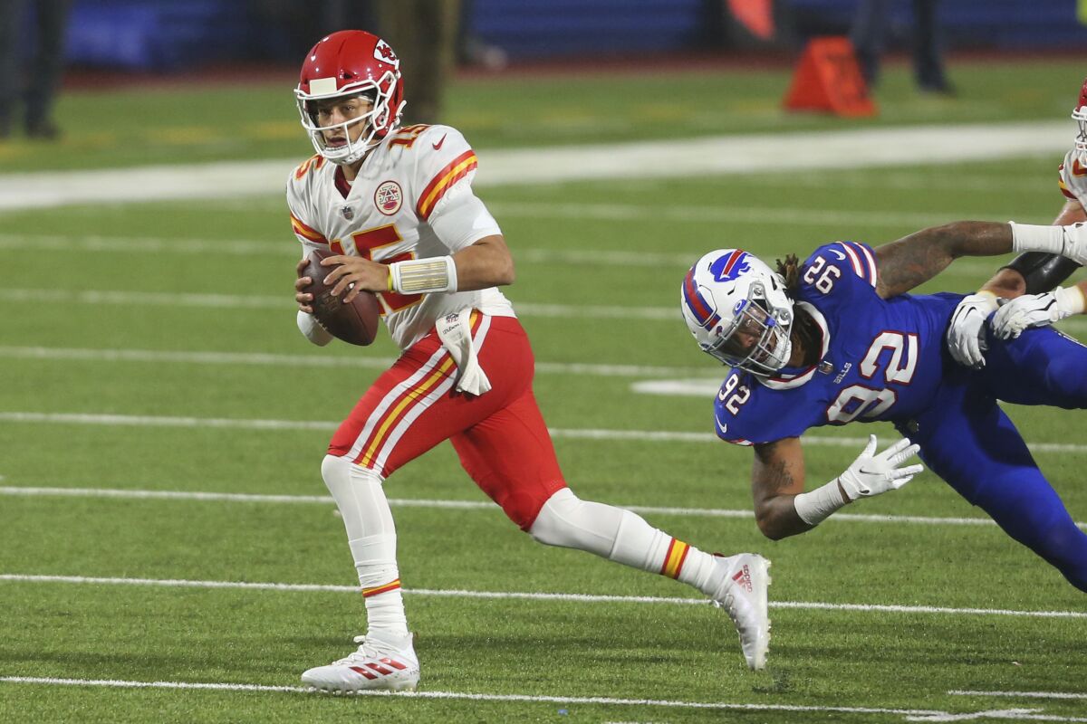 Kansas City Chiefs quarterback Patrick Mahomes carries the ball.