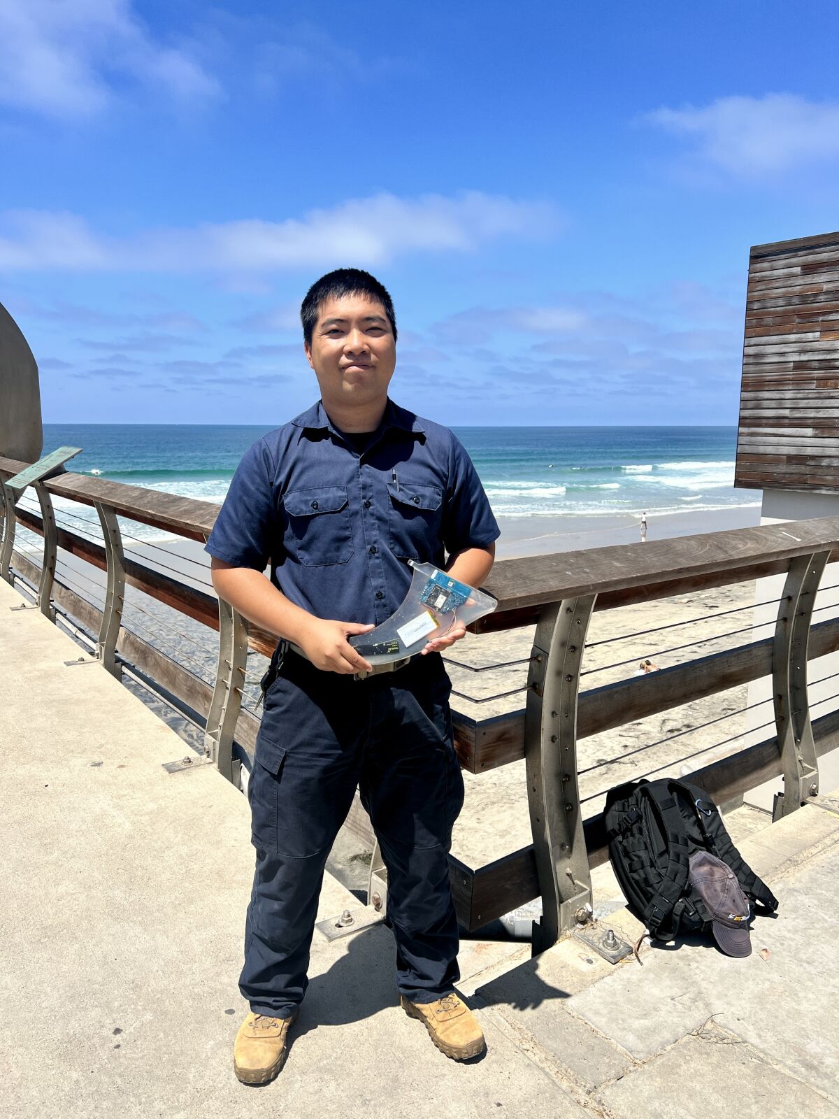 UC San Diego staff research engineer Nathan Hui holds the Smartfin.