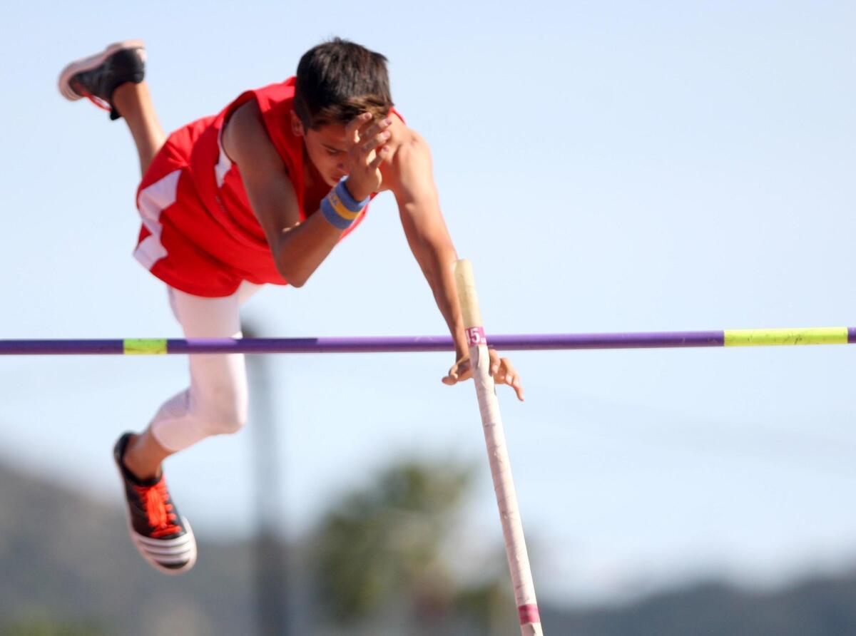 Burroughs High School's pole vaulter Christian Valles clears 12 feet in Pacific League track meet vs. Burbank High School, at Burroughs High School, in Burbank on Wednesday, April 20, 2016.