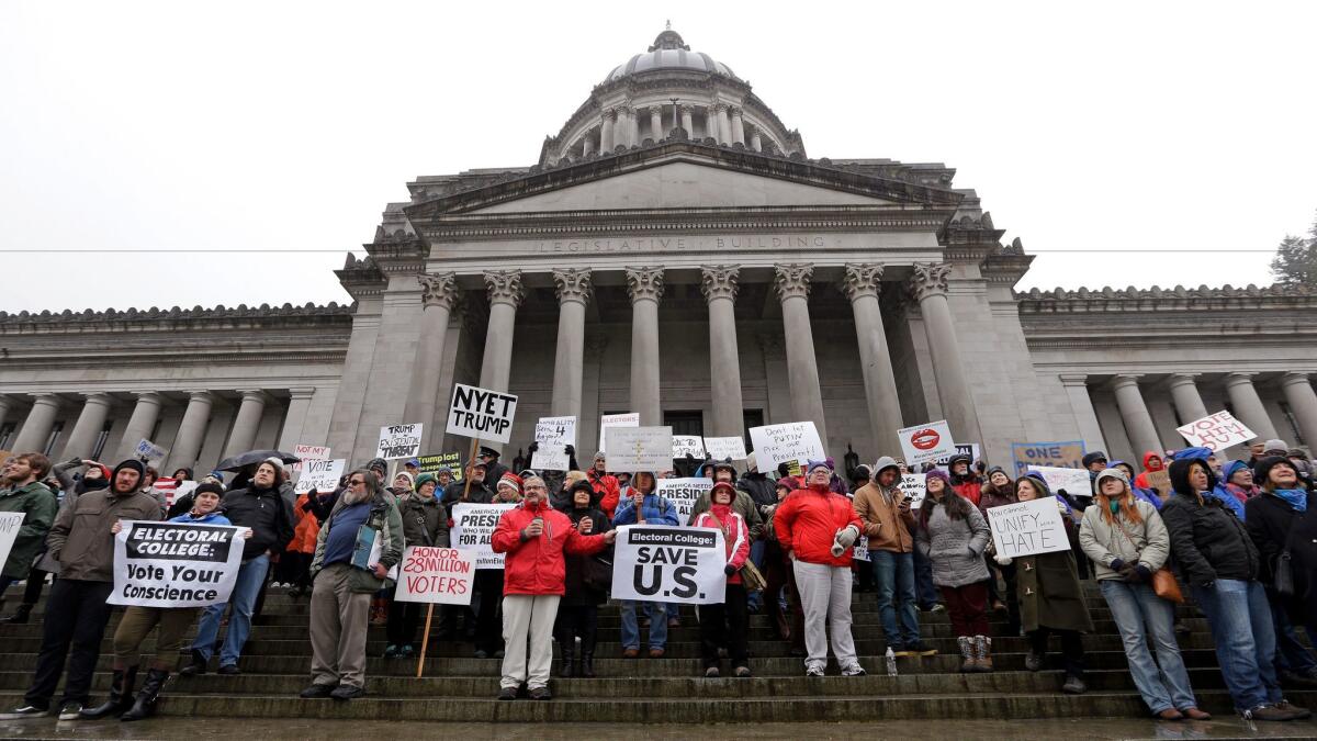 Protesters chant on the steps of the Washington statehouse on Monday in Olympia.
