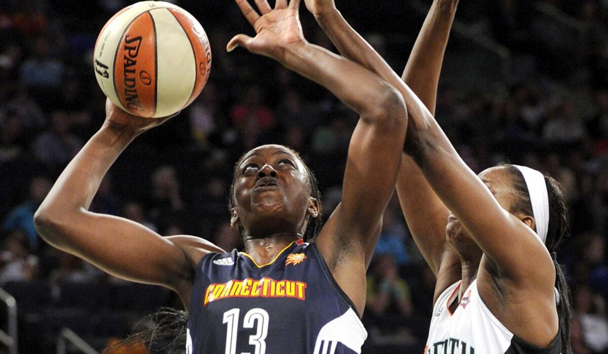 Sun forward Chiney Ogwumike (13) tries to score against Liberty forward Delisha Milton-Jones during a game at Madison Square Garden earlier this season.