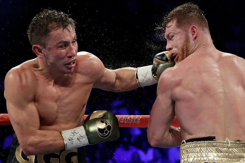 FILE - In this Sept. 17, 2017 file photo shows Gennady Golovkin, left, connects with a left to Canelo Alvarez during a middleweight title fight in Las Vegas. Golovkin is growing frustrated with boxing's sanctioning bodies while he struggles to find a replacement opponent for Canelo Alvarez on May 5. The unbeaten middleweight champion's rematch with Alvarez in Las Vegas fell through after the Mexican star failed a doping test in February and finally withdrew from the bout last week.(AP Photo/John Locher, File)