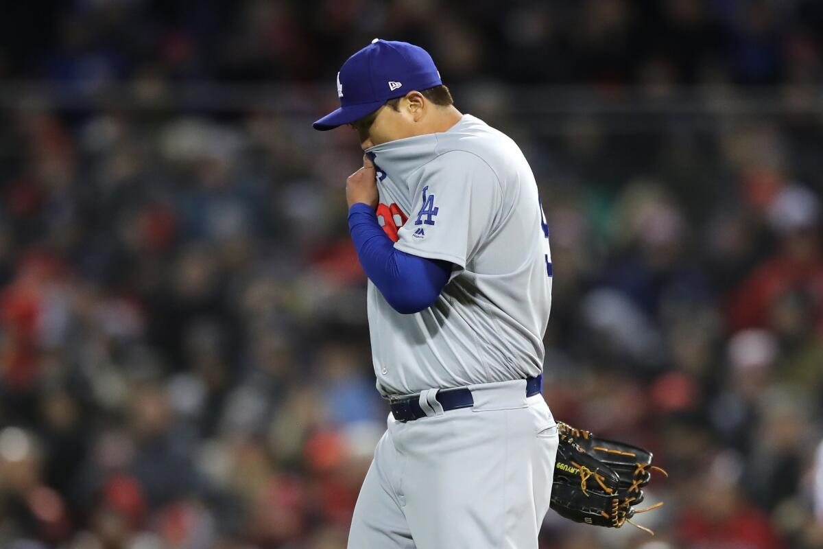 Hyun-Jin Ryu #99 of the Los Angeles Dodgers reacts after walking the batter during the fifth inning against the Boston Red Sox in Game Two of the 2018 World Series at Fenway Park on October 24, 2018 in Boston, Massachusetts.