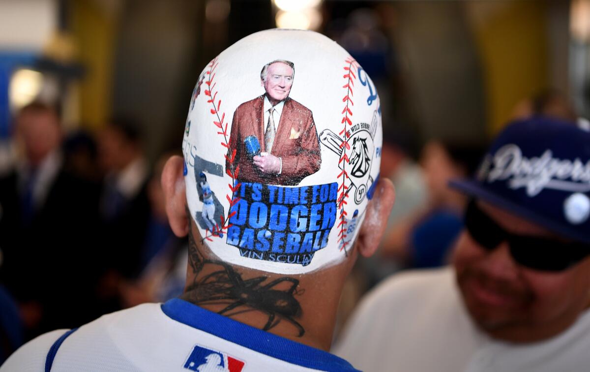 A fan honors former Dodgers announcer Vin Scully on the back of his head before opening day at Dodger Stadium.