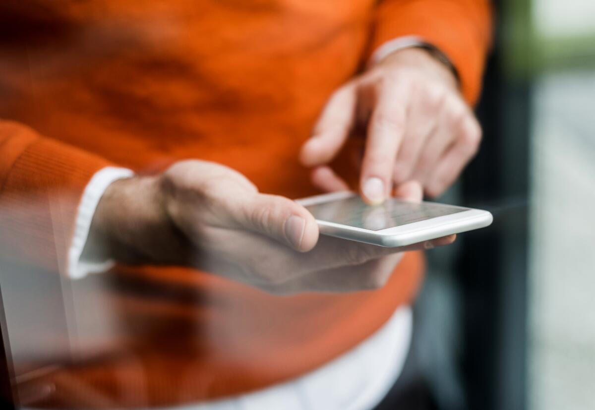 A person holds a cell phone 