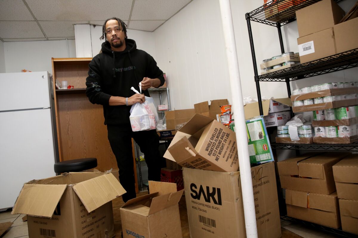 Volunteer Morice Jones prepares bags of food for distribution at a Los Angeles food bank.