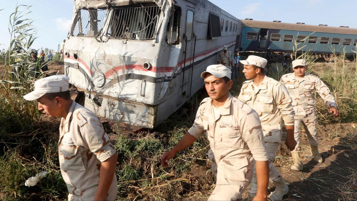 Military personnel attend the scene of a train collision outside Egypt's Mediterranean port city of Alexandria.