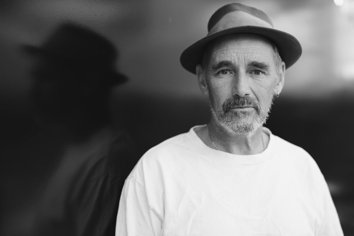 Black-and-white photo of a bearded man in a hat.