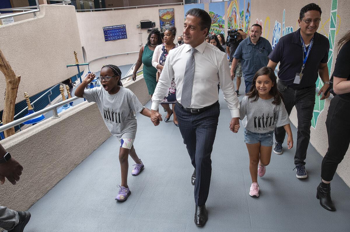 Students lead L.A. schools Supt. Alberto Carvalho up a ramp at Marlton School.