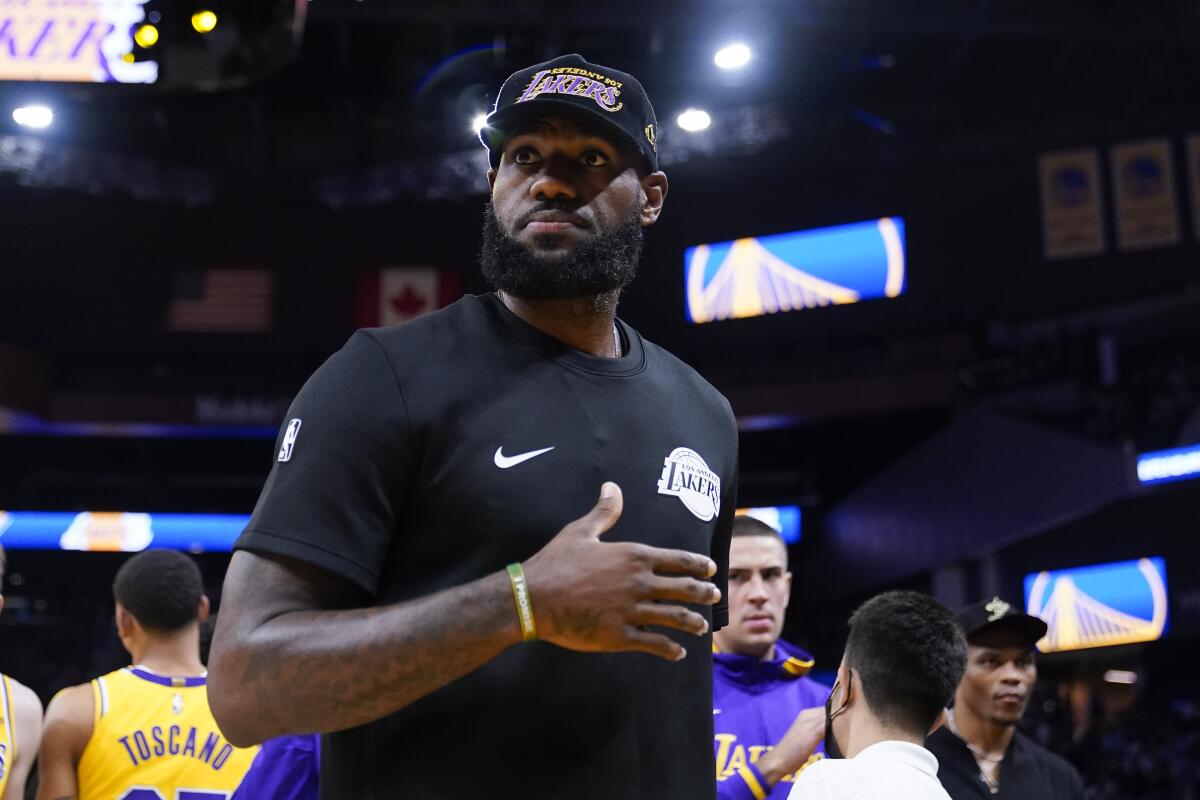 Lakers star LeBron James stands on the court before a game.
