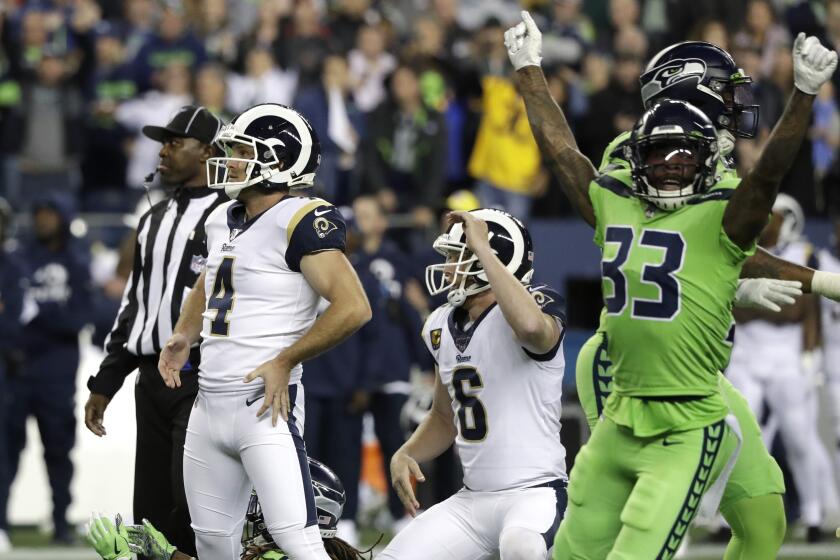 Los Angeles Rams' Greg Zuerlein (4) and Seattle Seahawks free safety Tedric Thompson (33) react after Zuerlein missed a field goal in the final seconds of an NFL football game Thursday, Oct. 3, 2019, in Seattle. The Seahawks won 30-29. (AP Photo/Elaine Thompson)