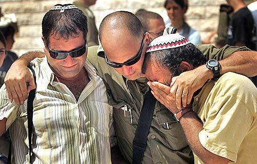 An Israeli soldier hugs settlers after a farewell party in Morag.