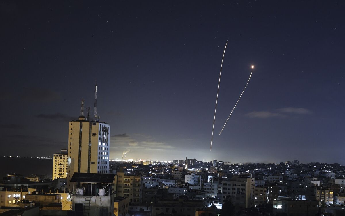 A streak of light appears as Israel's Iron Dome anti-missile system intercepts rockets launched from the Gaza Strip.