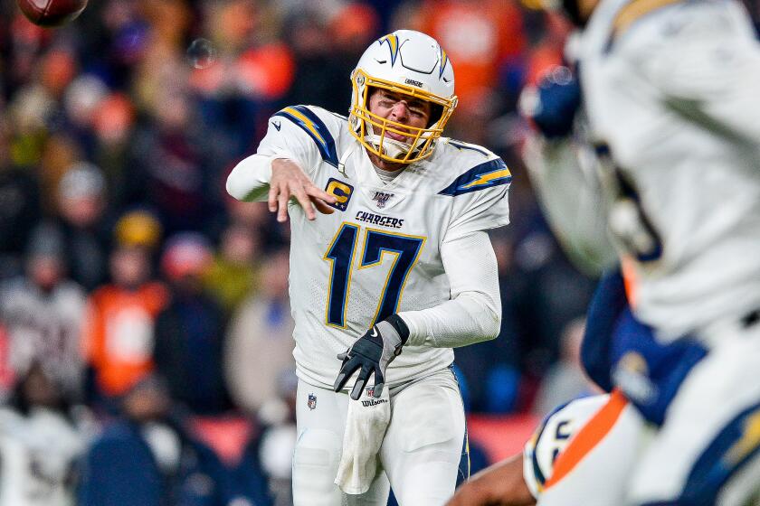 DENVER, CO - DECEMBER 1: Philip Rivers #17 of the Los Angeles Chargers completes a pass to Keenan Allen #13 in the fourth quarter of a game against the Denver Broncos at Empower Field at Mile High on December 1, 2019 in Denver, Colorado. (Photo by Dustin Bradford/Getty Images)