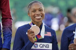 Allyson Felix, of the United States holds her bronz medal at the World Athletics Championships.