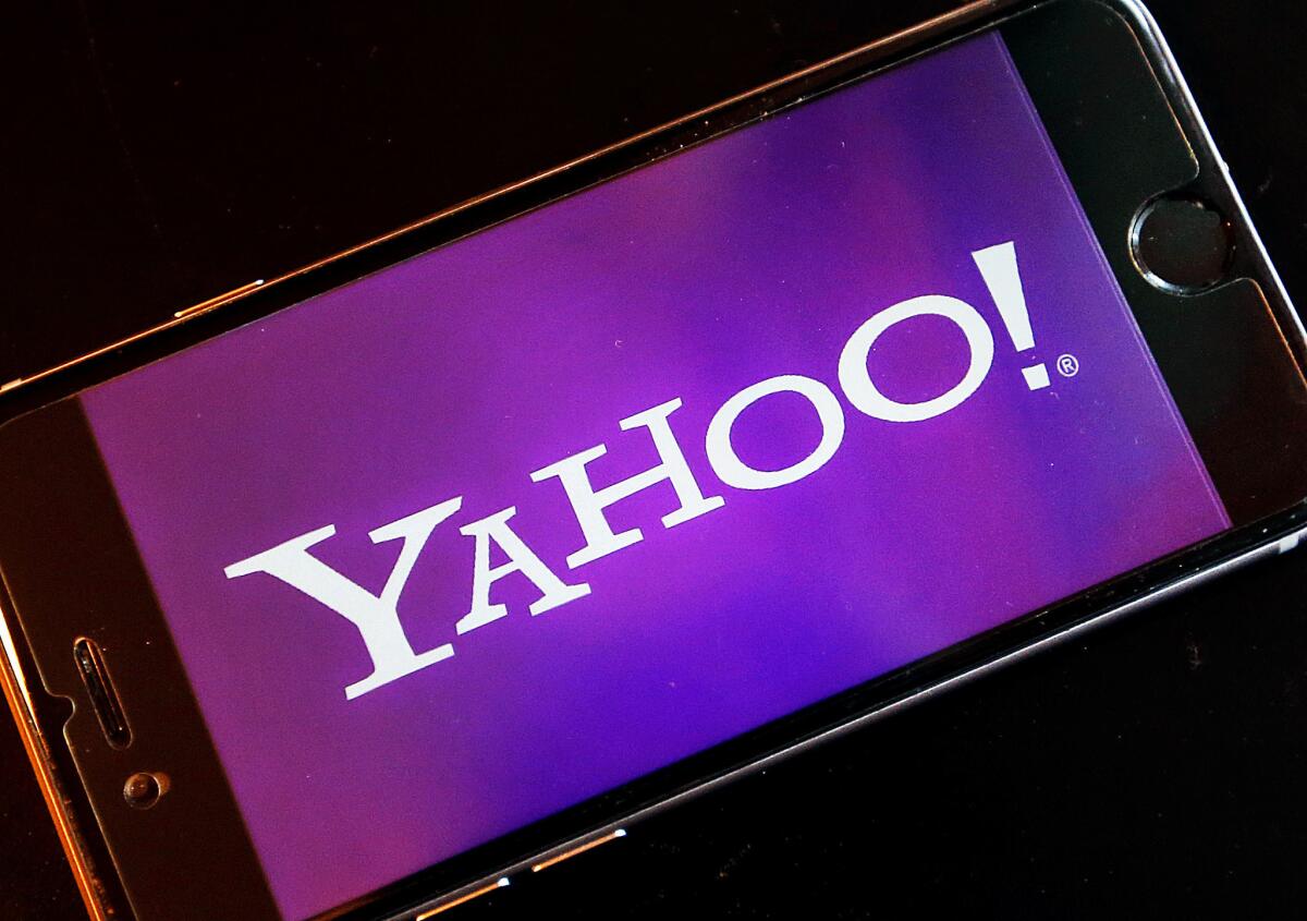 Yahoo's logo appears on a smartphone screen.