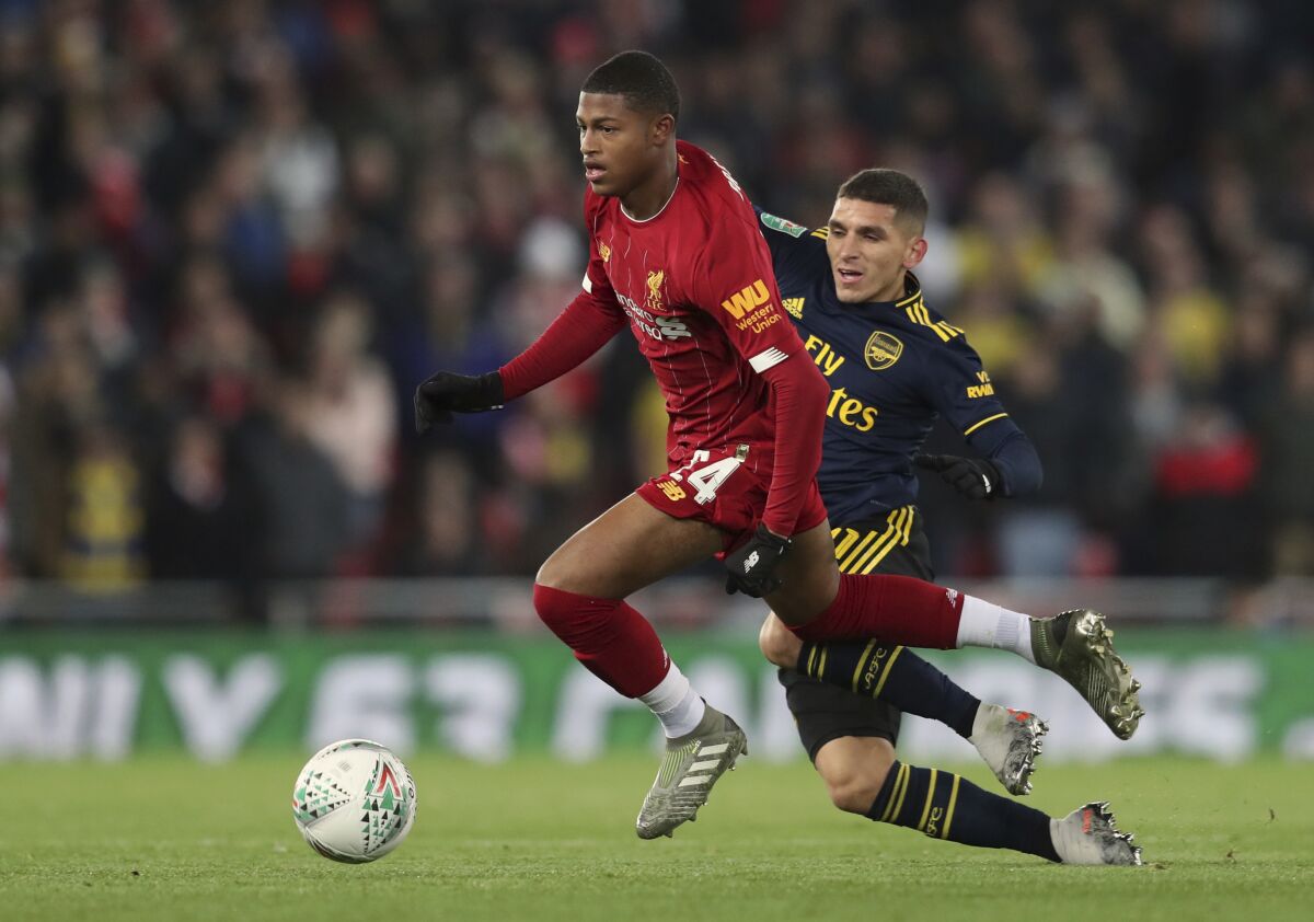 FILE - In this Wednesday, Oct. 30, 2019 file photo, Liverpool's Rhian Brewster, left, duels for the ball with Arsenal's Lucas Torreira during their English League Cup soccer match at Anfield stadium in Liverpool, England. Brewster has long been tipped as a future England striker — he played in the country's World Cup-winning under-17 team in 2017 — and there's no doubt he is a natural goalscorer. “In the decisive moments, he’s 100% there," Liverpool manager Jürgen Klopp said after a preseason friendly in Austria when Brewster scored two goals. (AP Photo/Jon Super, file)