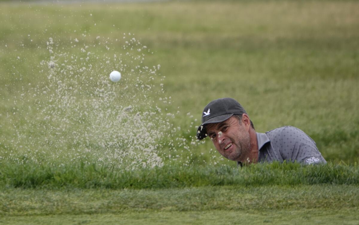 England's 48-year-old Richard Bland hits out of the sand on the eighth hole during the second round of the U.S. Open.