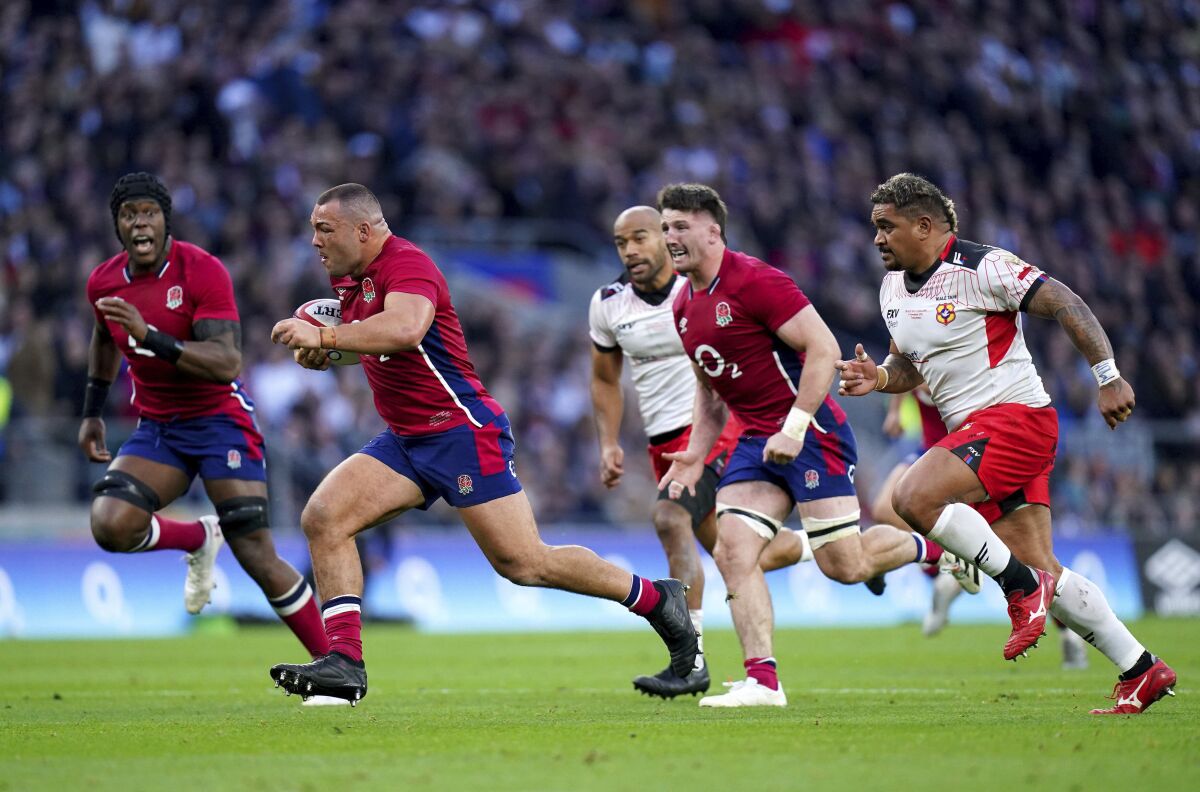 England's Ellis Genge, second right, sets up a try for team-mate Maro Itoje during the rugby union international match between England and Tonga, at Twickenham Stadium, in London, Saturday, Nov. 6, 2021. (Adam Davy/PA via AP)