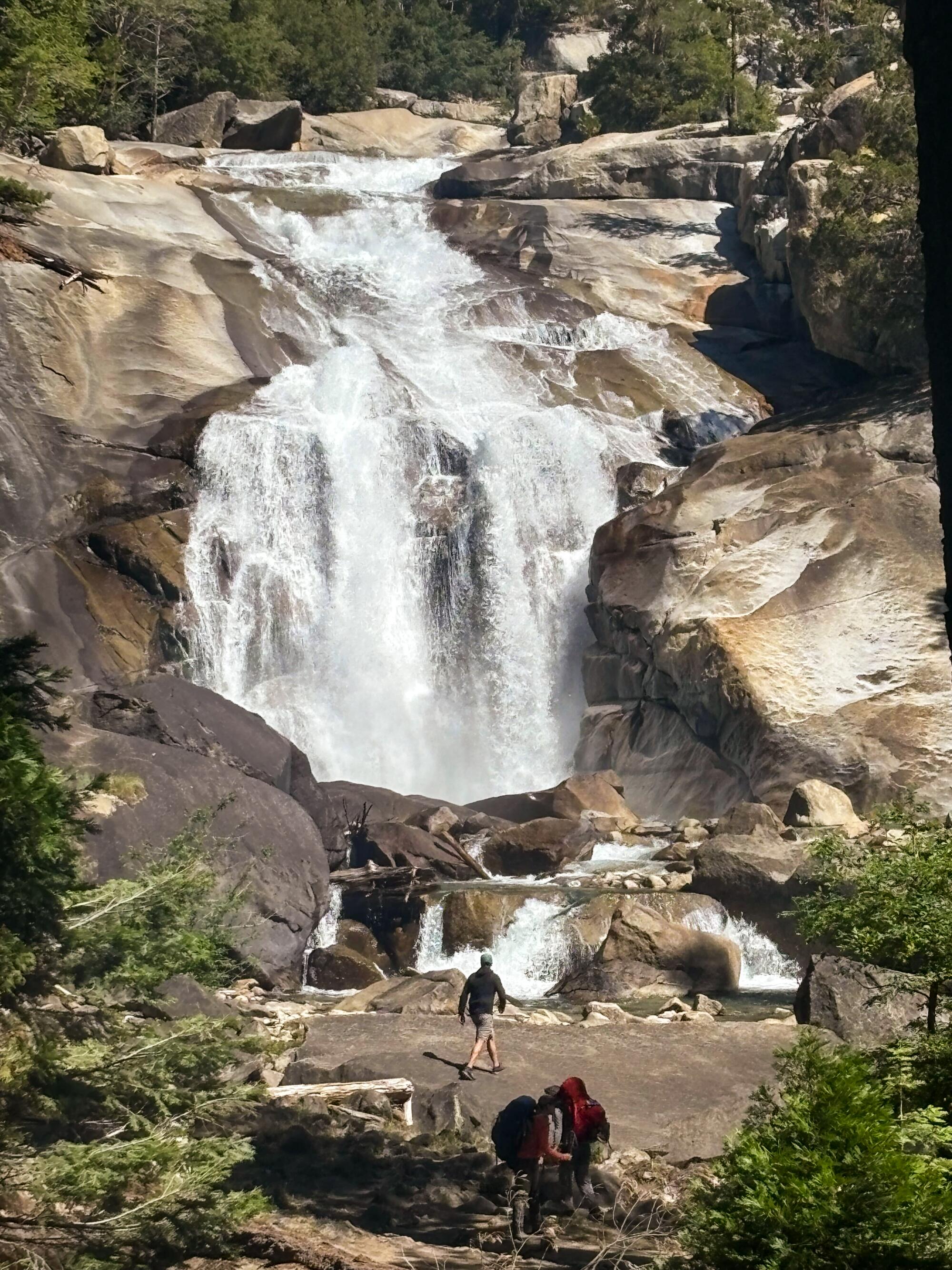 A massive waterfall cascading down into an emerald pool