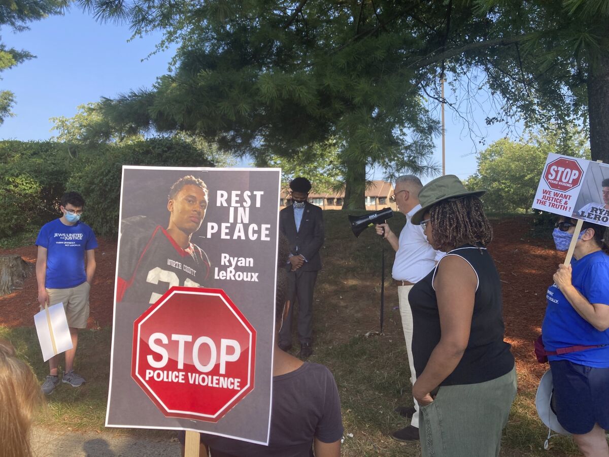 FILE - Activists gather for a vigil on Tuesday, July 27, 2021 near the McDonald's restaurant in Gaithersburg, Md. where Ryan LeRoux, a 21-year-old Black man, was shot and killed by police on July 16. Officials say four Maryland police officers won’t be charged in the fatal shooting of a 21-year-old Black man in a McDonald’s drive-thru last summer. News outlets report that the Montgomery County’s State’s Attorney’s Office announced Monday, April 5, 2022, that an investigation by prosecutors in neighboring Howard County into Ryan LeRoux’s death was complete and a grand jury found that the shooting was legally justified. (AP Photo/Michael Kunzelman, File)