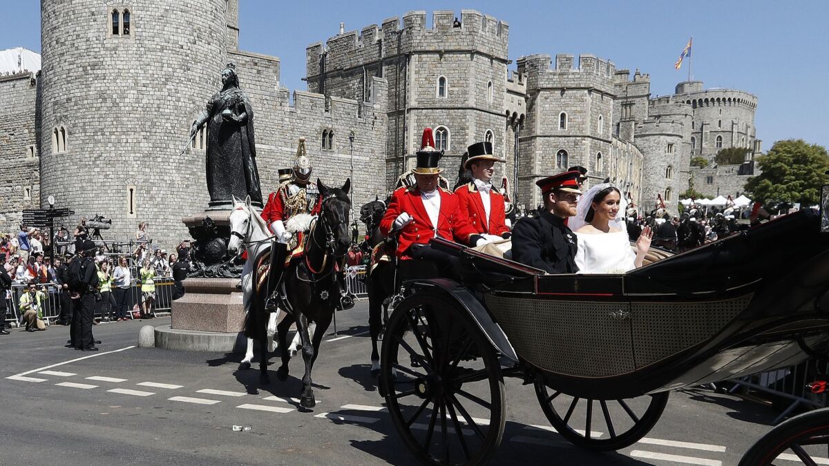 Britain's Prince Harry and Meghan Markle leave Windsor Castle after their wedding ceremony on May 19, 2018.
